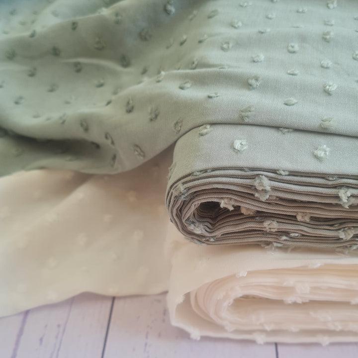 fabric with textured spots on - sage and cream colour
