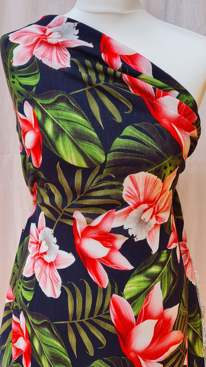 Tropical floral 100% Viscose crêpe dress fabric by the half metre. Navy blue.