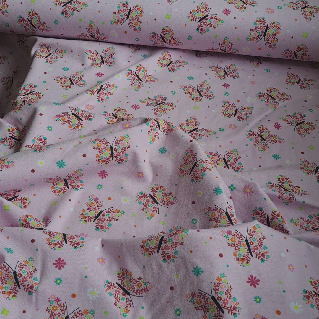 Tricot floral butterfly stretch cotton jersey knit fabric, by the half metre. Pink.